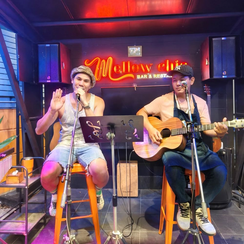 Live acoustic set under the neon sign